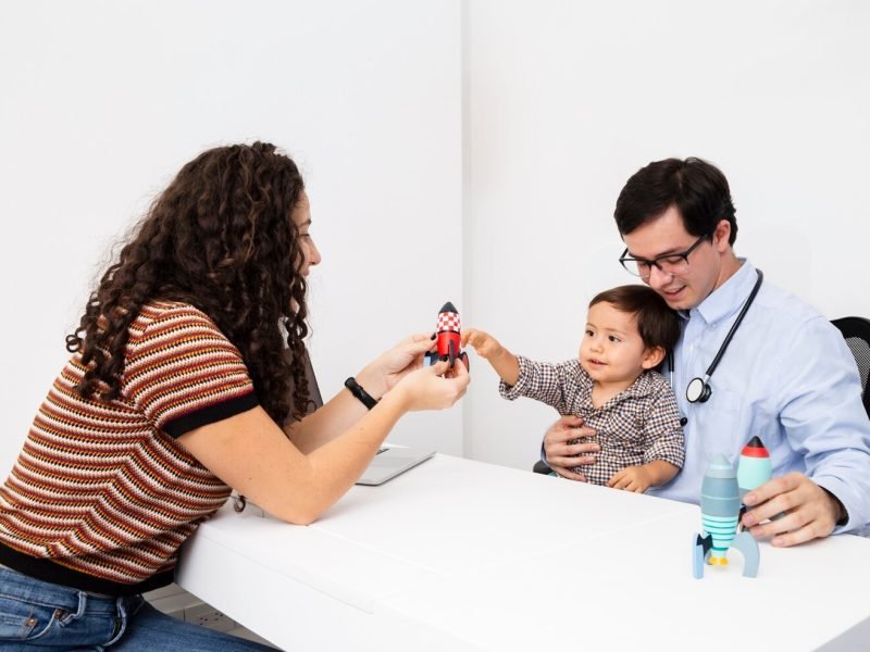 side-view-child-playing-with-toy-doctor-s-visit_23-2148231288